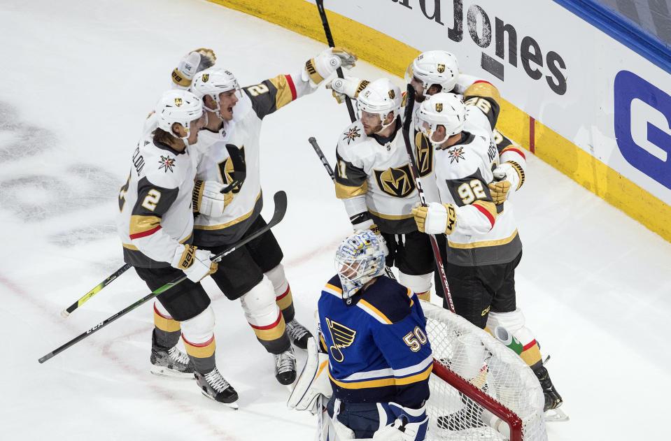 St. Louis Blues goalie Jordan Binnington (50) looks on as the Vegas Golden Knights celebrate a goal during second-period NHL hockey playoff game action in Edmonton, Alberta, Thursday, Aug. 6, 2020. (Jason Franson/The Canadian Press via AP)