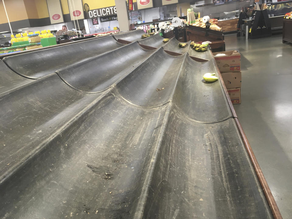 A nearly empty produce bin for bananas is shown at a grocery store in Anchorage, Alaska, on Sunday, Dec. 2, 2018, two days after a magnitude 7.0 earthquake was centered about 7 miles north of the city. Anchorage officials urged residents not to stock up and hoard supplies because the supply chain of goods was not interrupted. (AP Photo/Mark Thiessen)