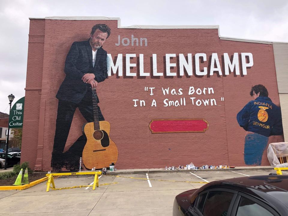 A mural of John Mellencamp by artist Pamela Bliss adorns the exterior of This Old Guitar Music Store in Seymour, Ind.