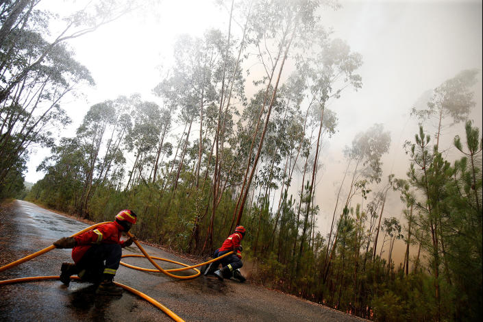 <p>Firefighters work to put out a forest fire next to the village of Macao, near Castelo Branco, Portugal, July 26, 2017. (Rafael Marchante/Reuters) </p>