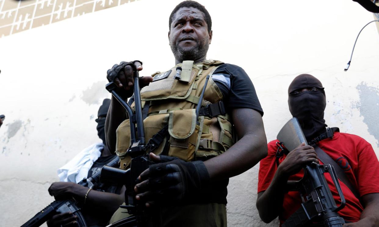 <span>Barbecue, the leader of the G9 gang, stands with his fellow gang members in Port-au-Prince earlier this week.</span><span>Photograph: Odelyn Joseph/AP</span>