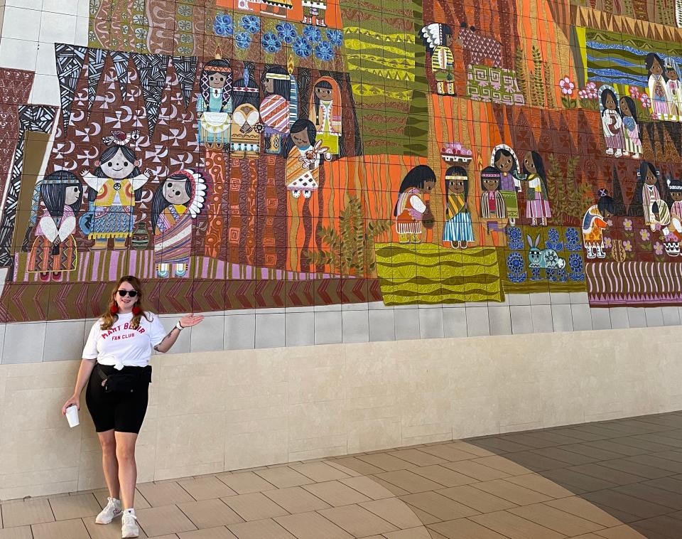 Jacqueline Dole posing in front of mural at disney contemperary with painted tiles