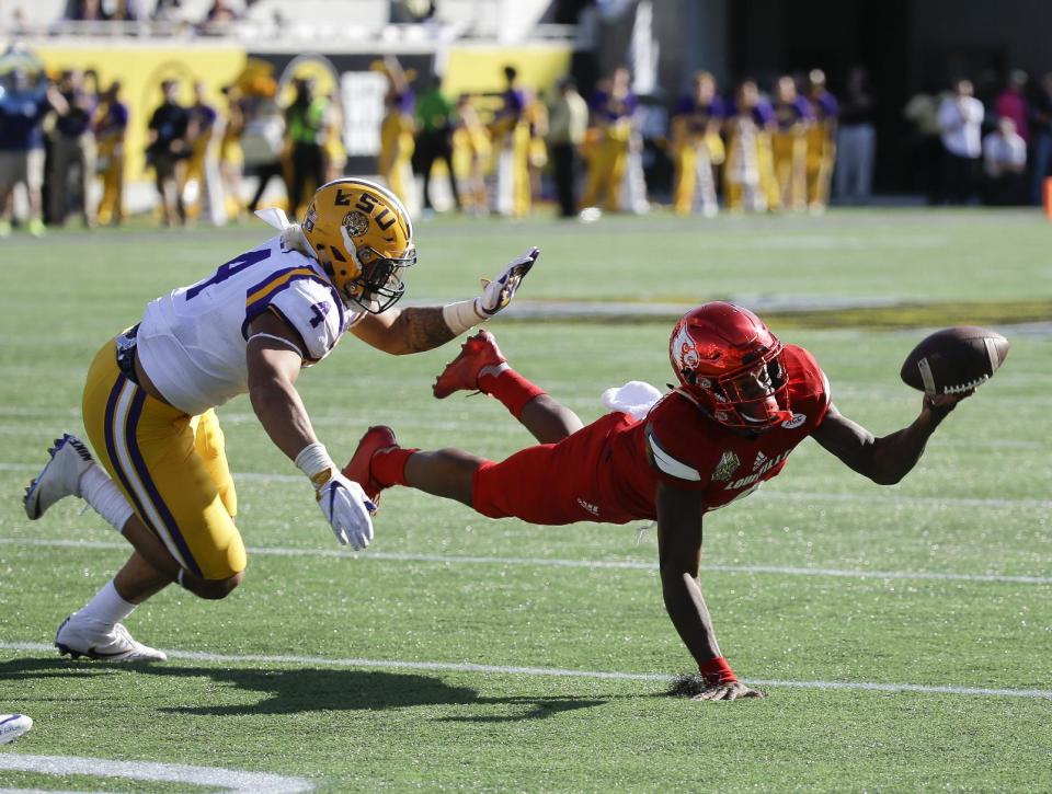 Louisville quarterback Lamar Jackson, right, is called for intentional grounding while throwing the ball as he is pressured by LSU linebacker Duke Riley (4) during the second half of the Citrus Bowl NCAA football game, Saturday, Dec. 31, 2016, in Orlando, Fla. LSU won 29-9. (AP Photo/John Raoux)