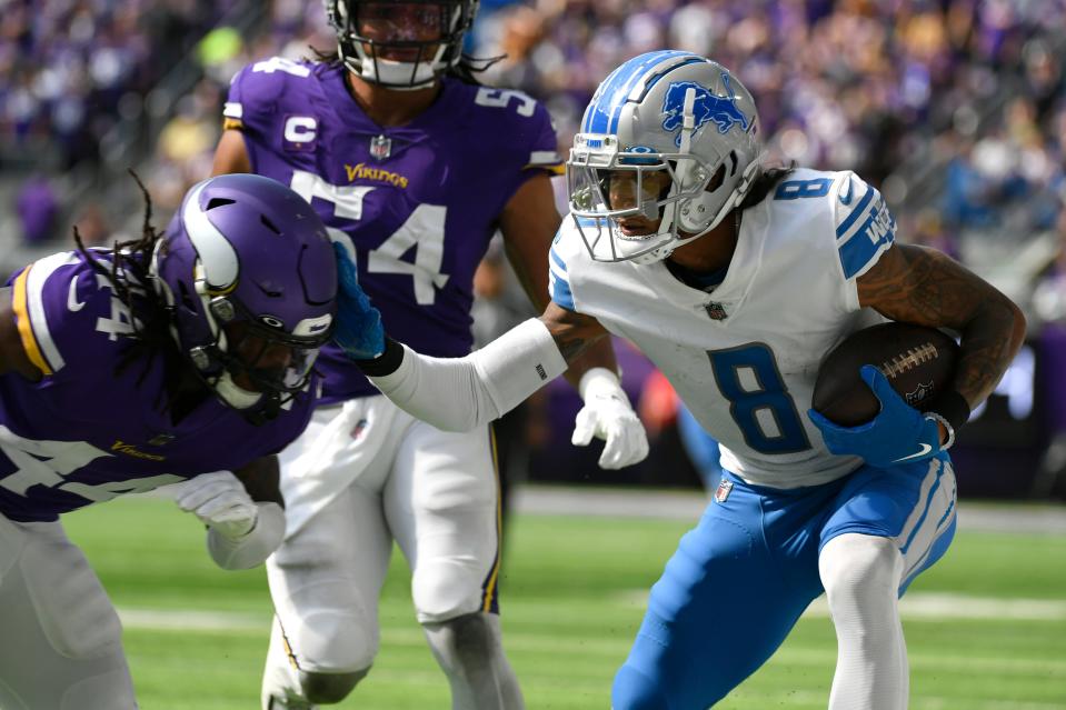 Lions wide receiver Josh Reynolds runs from Vikings safety Josh Metellus during the second half on Sunday, Sept. 25, 2022, in Minneapolis.