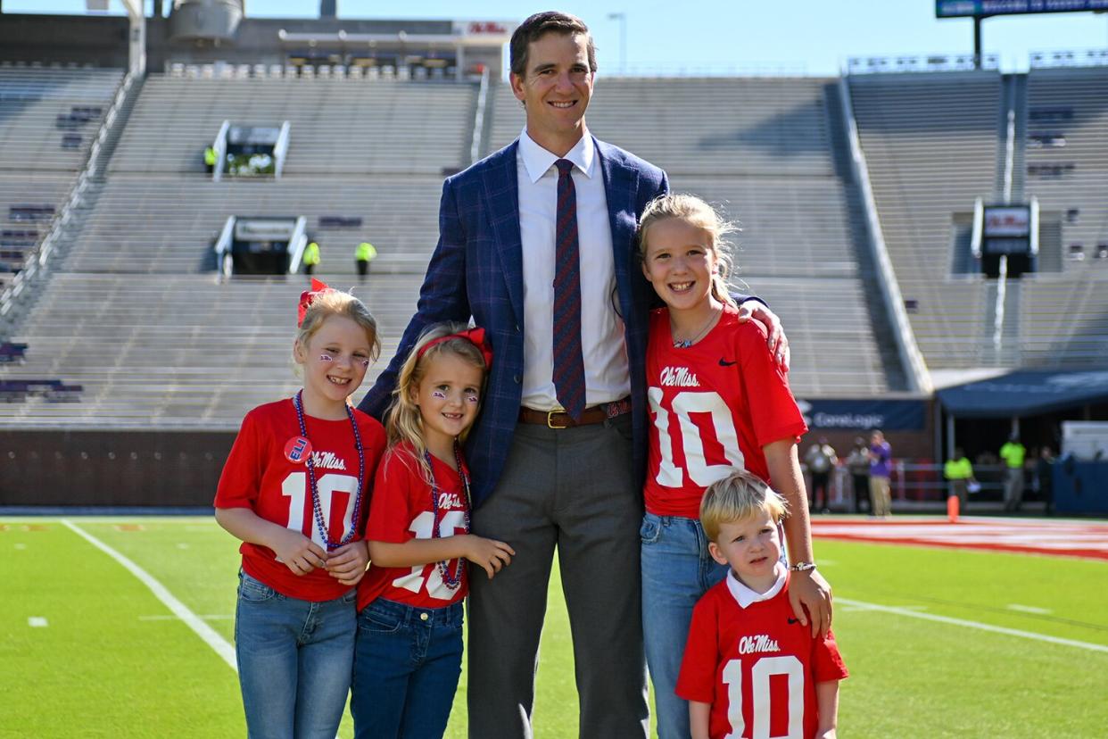 Former Ole' Miss and New York Giants quarterback, Eli Manning, poses with family members before the college football game between the LSU Tigers and the Ole Miss Rebels on October 23, 2021, at Vaught-Hemingway Stadium in Oxford, MS.