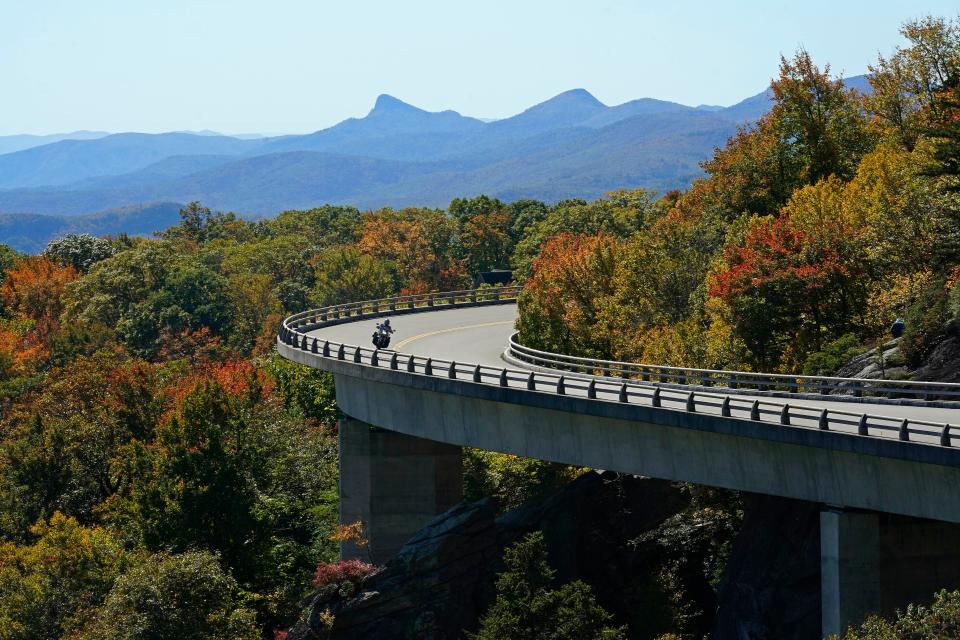 A motorcyclist navigates the Linn Cove Viaduct at Grandfather Mountain along the Blue Ridge Parkway near Linville, N.C., Monday, Oct. 18, 2021.