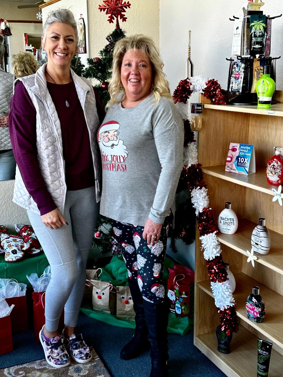 Cabana Tans owners Tani Pollock and Connie Gramm Maestas stand among the the items in their Farmington business being sold or raffled to raise cash for the Four Corners Home for Children.