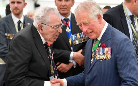 Charles, Prince of Wales (R) meets veterans after the the Royal British Legion Service of Remembrance at the Commonwealth War Graves Cemetery  - Credit: Getty