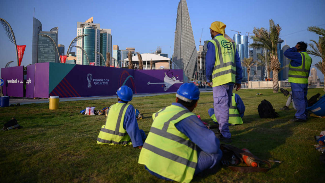 Workers take a break on the Corniche in Doha on November 15, 2022, ahead of the Qatar 2022 World Cup football tournament. (Photo by Anne-Christine POUJOULAT / AFP)