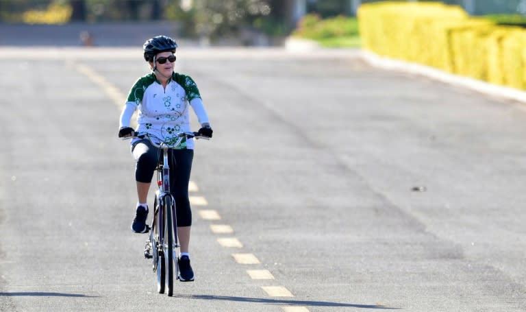 Suspended Brazilian President Dilma Rousseff rides her bicycle in the area of the Alvorada Palace in Brasilia on August 28, 2016