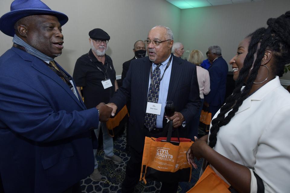 Jacksonville activist Ben Frazier (left), District Judge Brian Davis (center) and T-Neisha Tate (right), who oversees Social Responsibility and Impact for the Jacksonville Jaguars talk during the VIP meet and greet at Thursday evening's kickoff for the inaugural Jacksonville Civil Rights Conference. The first Jacksonville Civil Rights Conference kicked off on Aug. 25, 2022 at the Southbank Marriott.