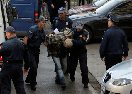 Montenegrin police escort men to a court session with the state attorney in Podgorica, Montenegro, October 16, 2016. REUTERS/Stevo Vasiljevic