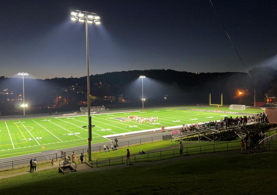 Stadium-style lights shine on the newly refurbished football field at halftime.