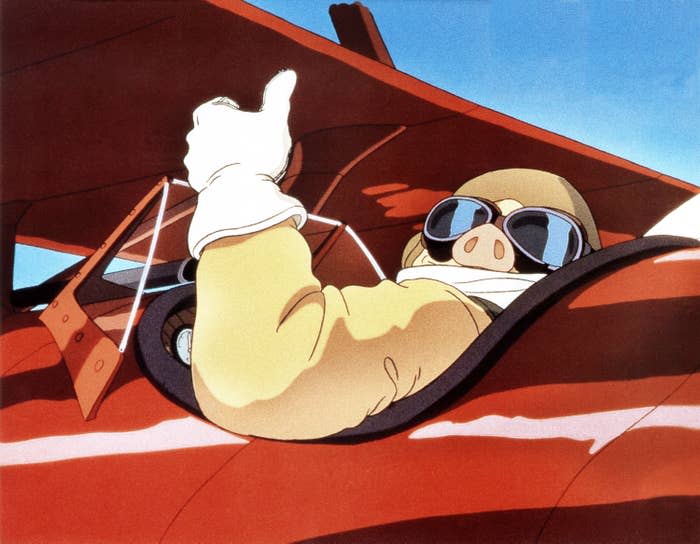 Porco from "Porco Rosso" giving a thumbs up un his red fighter plane