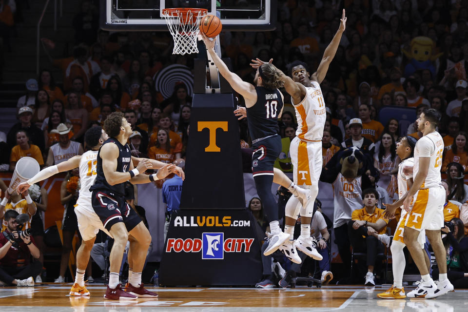 South Carolina forward Hayden Brown (10) shoots past Tennessee forward Tobe Awaka (11) during the first half of an NCAA college basketball game Saturday, Feb. 25, 2023, in Knoxville, Tenn. (AP Photo/Wade Payne)