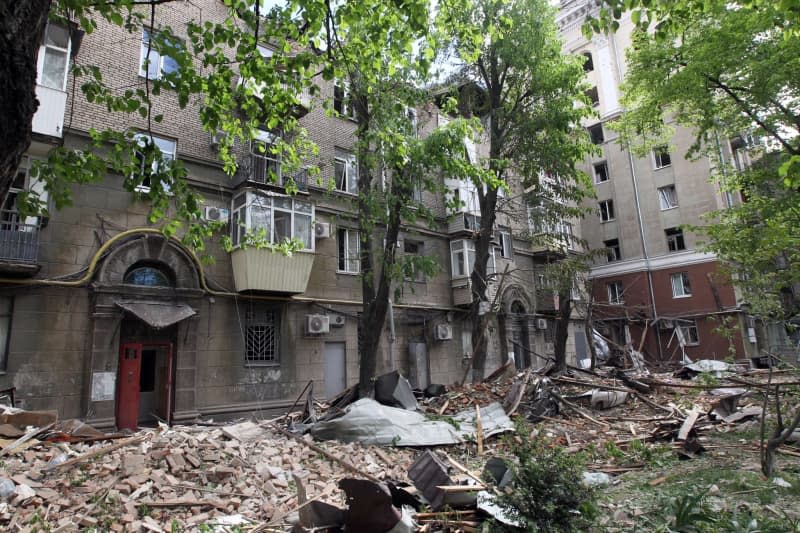 Debris covers the ground at an apartment block that was partially destroyed by the Russian missile attack on Dnipro. -/Ukrinform/dpa