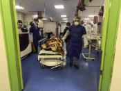 A medic moves a patient in a ward dedicated for people infected with the coronavirus, at Forqani Hospital, in Qom, 78 miles (125 kilometers) south of the capital Tehran, Iran, Wednesday, Feb. 26, 2020. Iran's president said Tehran has no immediate plans to quarantine cities over the new coronavirus rapidly spreading across the country, even as the Islamic Republic suffers the highest death toll outside of China with 19 killed amid 139 cases confirmed on Wednesday. (Mohammad Mohsenzadeh/Mizan News Agency via AP)