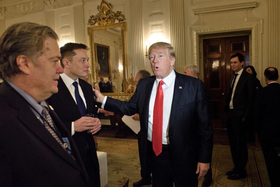 Trump adviser Steve Bannon (L) looks on as US President Donald Trump greets Elon Musk, the CEO of SpaceX and Tesla, before a policy and strategy forum with executives in the State Dining Room of the White House on February 3, 2017 in Washington , DC.  / AFP / Brendan Smialowski (Photo credit should be BRENDAN SMIALOWSKI/AFP via Getty Images)