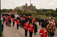 <p>The State Hearse carrying the coffin of Queen Elizabeth II drives along Albert Road, Windsor on its journey from the state funeral at Westminster Abbey, London, to a committal service at St George's Chapel in Windsor Castle. (PA)</p> 