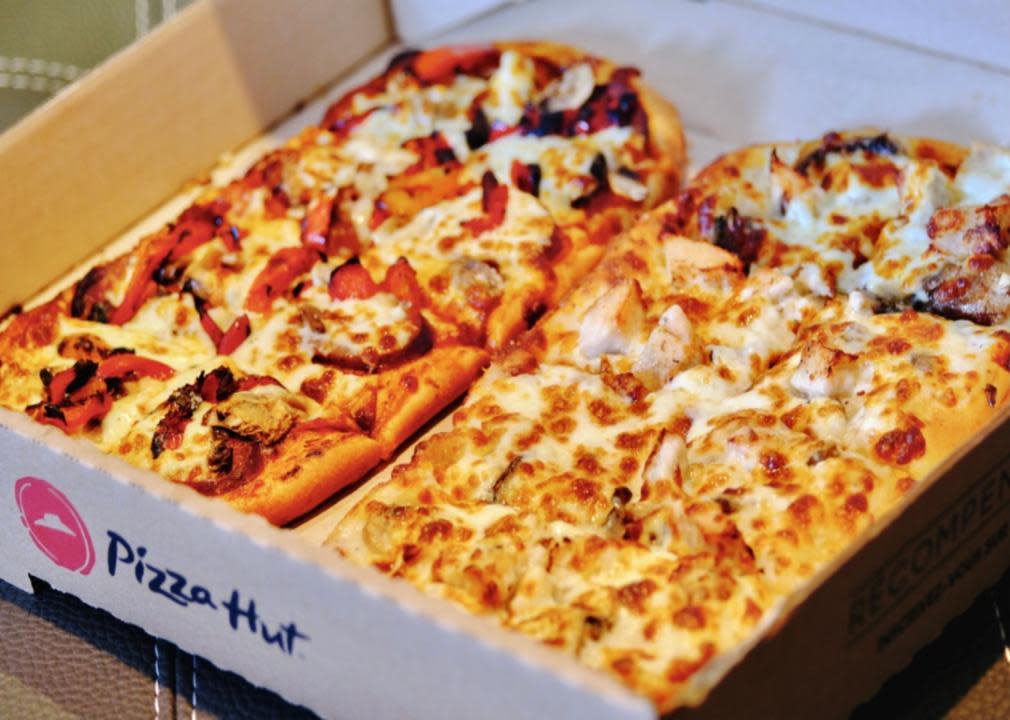 Two different flatbreads in a Pizza Hut box.