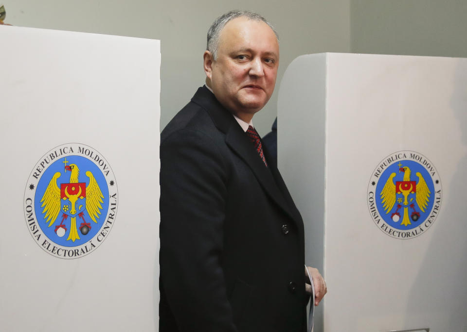 FILE - In this Sunday, Feb. 24, 2019 file photo, Moldova's President Igor Dodon exits a voting cabin in Chisinau, Moldova. A Moldovan court has appointed former prime minister Pavel Filip as interim president, a day after a new government was formed following a months-long political stalemate. The Constitutional Court said Sunday, June 9 that Igor Dodon, who supported the new government, was being relieved of his duties for failing to comply with its ruling to dissolve parliament. (AP Photo/Vadim Ghirda, File)