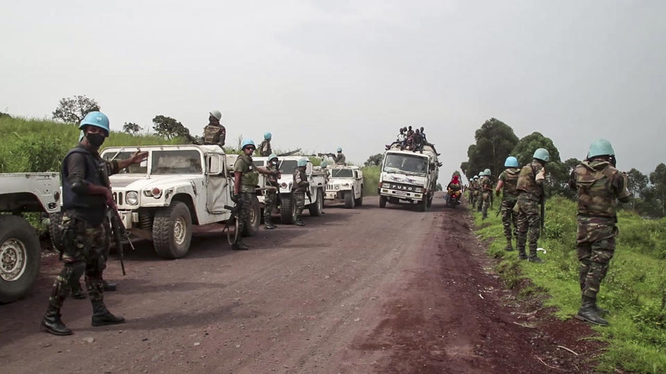 In this image from video, United Nations peacekeepers guard the area where a U.N. convoy was attacked and the Italian ambassador to Congo killed, in Nyiragongo, North Kivu province, Congo Monday, Feb. 22, 2021. The Italian ambassador to Congo Luca Attanasio, an Italian carabineri police officer and their Congolese driver were killed Monday in an attack on a U.N. convoy in an area that is home to myriad rebel groups, the Foreign Ministry and local people said. (AP Photo/Justin Kabumba)