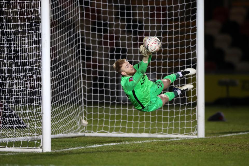 TOPSHOT - Brighton's English goalkeeper Jason Steele saves a penalty from Newport County's Welsh defender Liam Shephard (not seen) during the penalty shoot-out in the English FA Cup third round football match between Newport County and Brighton and Hove Albion at Rodney Parade in Newport, south Wales on January 10, 2021. (Photo by Nick Potts / POOL / AFP) / RESTRICTED TO EDITORIAL USE. No use with unauthorized audio, video, data, fixture lists, club/league logos or 'live' services. Online in-match use limited to 120 images. An additional 40 images may be used in extra time. No video emulation. Social media in-match use limited to 120 images. An additional 40 images may be used in extra time. No use in betting publications, games or single club/league/player publications. /  (Photo by NICK POTTS/POOL/AFP via Getty Images)