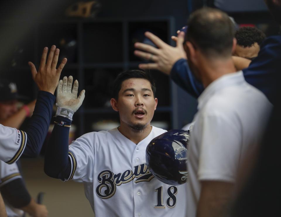 Milwaukee Brewers' Keston Hiura is congratulated after hitting a home run during the fourth inning of a baseball game against the St. Louis Cardinals Wednesday, Aug. 28, 2019, in Milwaukee. (AP Photo/Morry Gash)