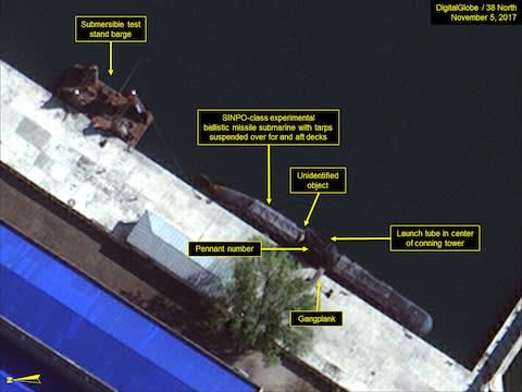 SINPO-class submarine and submersible test stand barge berthed in the secure boat basin - Credit:  DigitalGlobe/ScapeWare3d