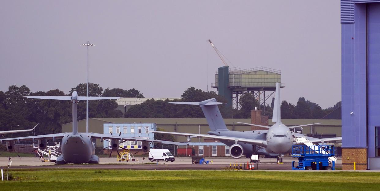Planes stand after the arrival of the first flight of people evacuated from Kabul at RAF Brize Norton, England on Monday, Aug. 16, 2021. International nations have scrambled to evacuate their diplomats, local allies and their families from Kabul, following the fall of the Western-backed Afghanistan government to the Taliban.