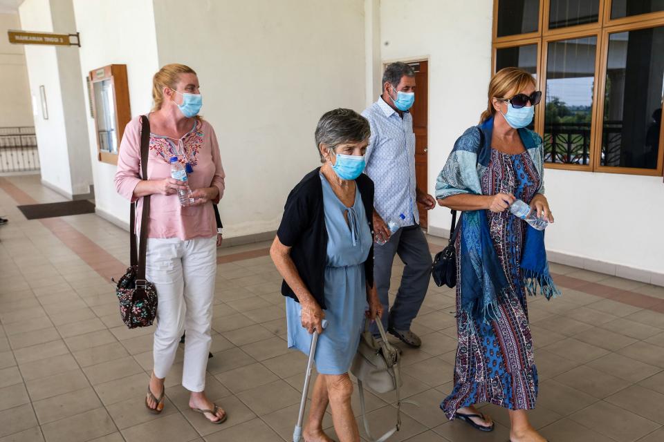 A group of people believed to be relatives of the accused British national Samantha Jones, leaves the courtroom after the court took a break where Jones faces trial in Alor Setar, northern Malaysia, on August 3, 2020. - Jones was arrested two years ago after her husband John William Jones was found with a stab wound to his chest in his house on the Malaysian holiday island of Langkawi. (Photo by A. Ammarudin / AFP) (Photo by A. AMMARUDIN/AFP via Getty Images)