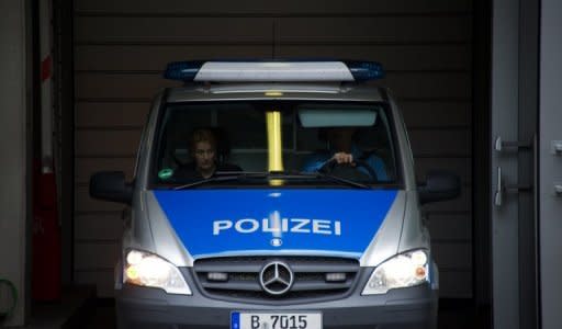 A police car transports Luka Rocco Magnotta (unseen) from the main detention center in Berlin. The porn actor dubbed the "Canadian Psycho" for allegedly killing and chopping up another man has told a Berlin judge he would not challenge his extradition from Germany