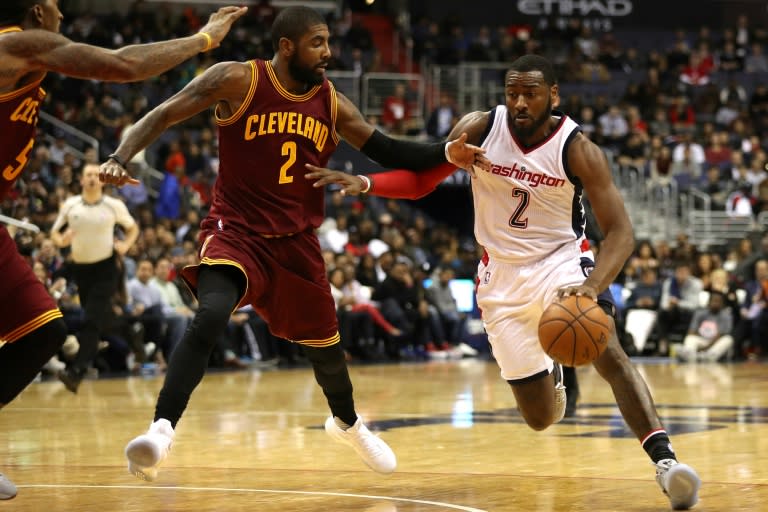 John Wall of the Washington Wizards drives past Kyrie Irving f the Cleveland Cavaliers during the second half at Verizon Center