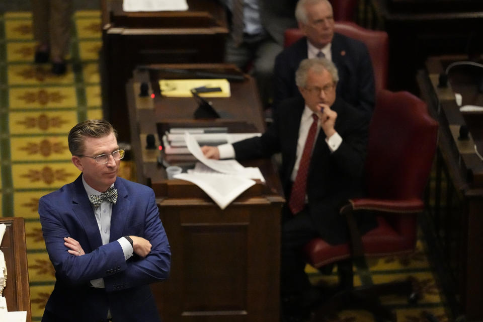 Rep. Ryan Williams, R-Cookeville, left, listens to debate of his bill to allow some teachers to be armed in schools on the House floor during a legislative session Tuesday, April 23, 2024, in Nashville, Tenn. (AP Photo/George Walker IV)