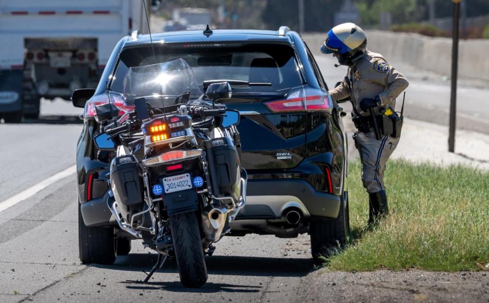 A California Highway Patrol officer conducts a traffic stop in an undated photo.
