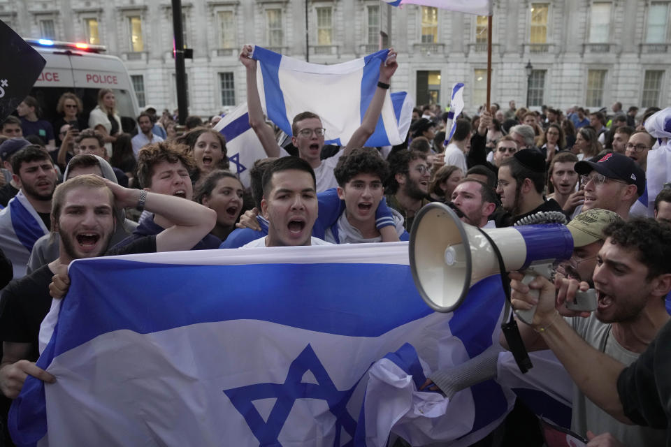Protesters shout during the 'Jewish Community Vigil' for Israel in London, Monday, Oct. 9, 2023 two days after Hamas fighters launched an unprecedented, multi-front attack on Israel which killed more than 700 people. The militants blew through a fortified border fence and gunned down civilians and soldiers in Israeli communities along the Gaza frontier during a Jewish holiday. (AP Photo/Kin Cheung)