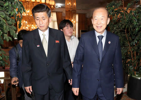 South Korea's delegation leader Park Kyung-seo, head of the Korean Red Cross, and North Korea's delegation leader Pak Yong-il, vice chairman of the Committee for the Peaceful Reunification of the Country, arrive for their meeting at a hotel on Mount Kumgang, North Korea, June 22, 2018. Yonhap via REUTERS