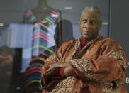 FILE - André Leon Talley, a former editor at large for Vogue magazine, speaks to a reporter at the opening of the "Black Fashion Designers" exhibit at the Fashion Institute of Technology in New York, Tuesday, Dec. 6, 2016. Talley, the towering former creative director and editor at large of Vogue magazine, has died. He was 73. Talley's literary agent confirmed Talley's death to USA Today late Tuesday, Jan. 18, 2022. (AP Photo/Seth Wenig, File)