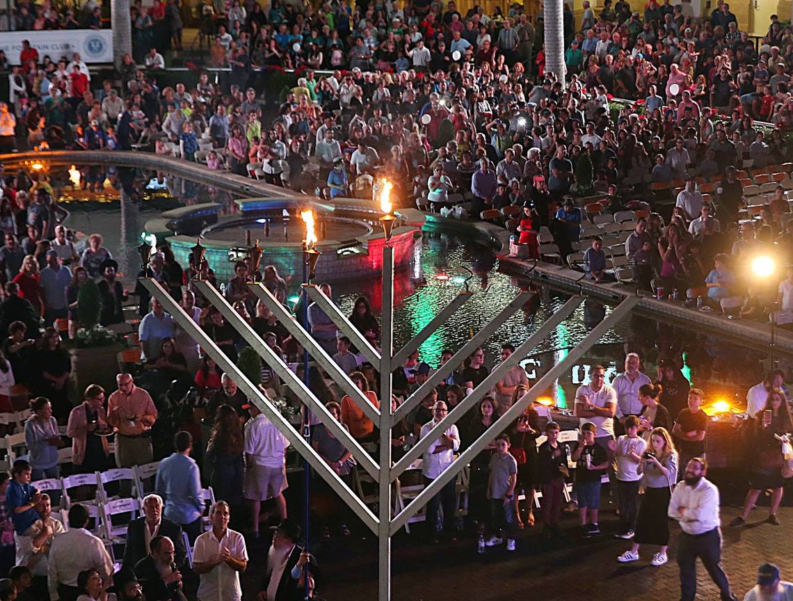 Guests look up as the menorah is lit at a chabad event at Gulfstream Park in Hallandale Beach in 2016.