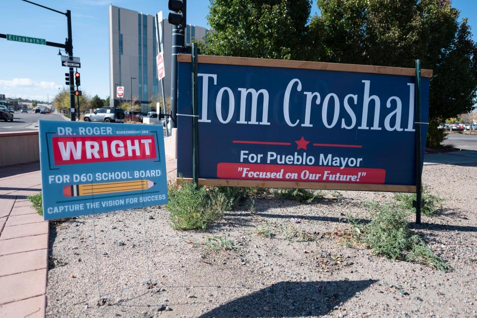 Campaign signs can be seen at the corner of Fourth Street and Elizabeth Street in downtown Pueblo.