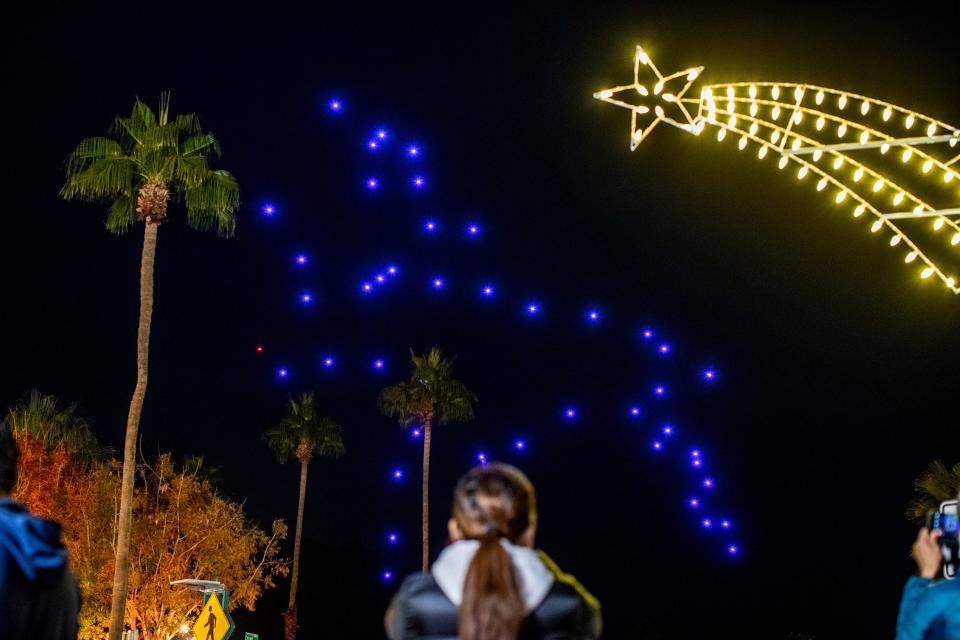 Drones form the outline of Rudolph the Red-Nosed Reindeer in the sky during the Palm Springs Holiday Tree Lighting festivities at Frances Stevens Park in Palm Springs, Calif., on Friday, Dec. 2, 2022. 