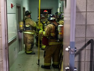 Fire fighters inspect the East High electrical room — Salt Lake Tribune