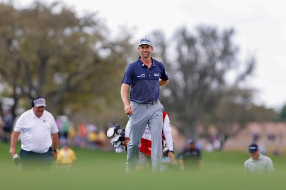 Webb Simpson walks on the eighth hole green during the first round of the Honda Classic golf tournament.