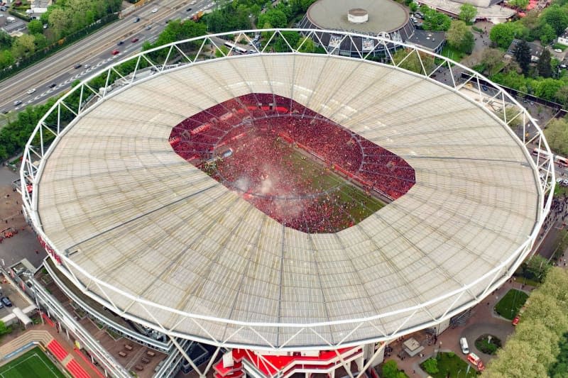 An aerial view taken with a drone shows Leverkusen fans in the pitch to celebrate winning the German championship following the German Bundesliga soccer match between Bayer 04 Leverkusen and SV Werder Bremen at BayArena. Christoph Reichwein/dpa