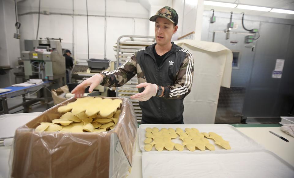 Jake Fabry, co-owner, boxes up freshly made ravioli at Bozza Pasta shop in Hilton Monday, March 23, 2020.