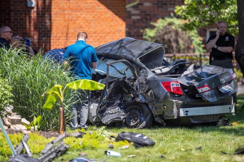 Police and emergency responders looked over the scene of a three-vehicle crash at Eastland Parkway and Gayle Drive in Lexington Wednesday. One driver was killed and another was seriously injured.