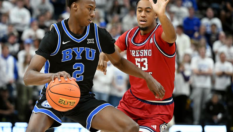 BYU guard Jaxson Robinson works against Fresno State guard Xavier DuSell at the Delta Center in Salt Lake City on Friday, Dec. 1, 2023. The BYU sixth man has made a splash since coming off the bench for the Cougars this season.