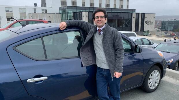 Saman Bazmi stands next to 'the Tiger of Newfoundland,' his first car, which he bought last summer.