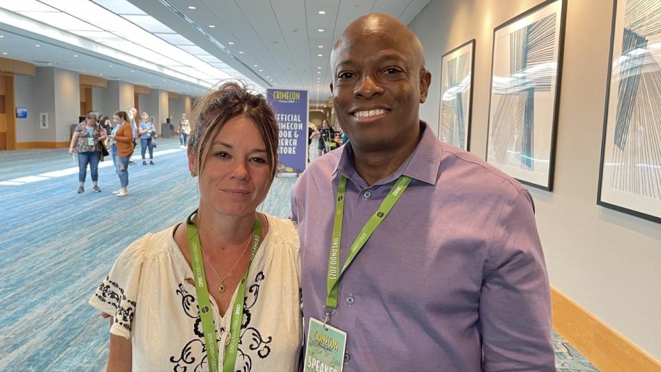 David Robinson and Candice Cooley pose in a hallway at a conference center