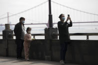 Residents walk along the banks of the Yangtze River in Wuhan in central China's Wuhan province on Wednesday, April 1, 2020. Skepticism about China’s reported coronavirus cases and deaths has swirled throughout the crisis, fueled by official efforts to quash bad news in the early days and a general distrust of the government. In any country, getting a complete picture of the infections amid the fog of war is virtually impossible. (AP Photo/Ng Han Guan)